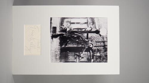 GENE KELLY 'SINGIN IN THE RAIN':  a mounted, black and white photograph, with inset signature, signed on the back of a 'Singin' In the Rain' part scri