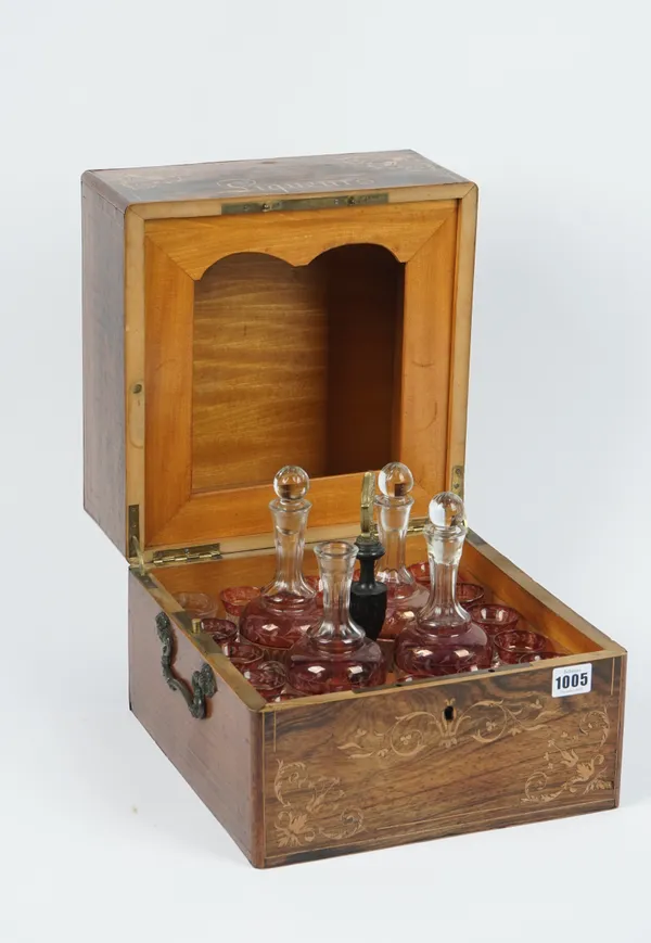 A Victorian rosewood and inlaid liqueur box, the interior fitted with a suite of glassware, 30cm wide.