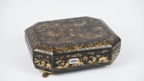 A 19th century Cantonese export lacquer box, chinoiserie decorated, of canted rectangular form with further smaller boxes to the interior, on four lio