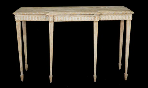 A modern limed oak breakfront side table with single frieze drawer on fluted tapering supports, 129cm wide x 79cm high.