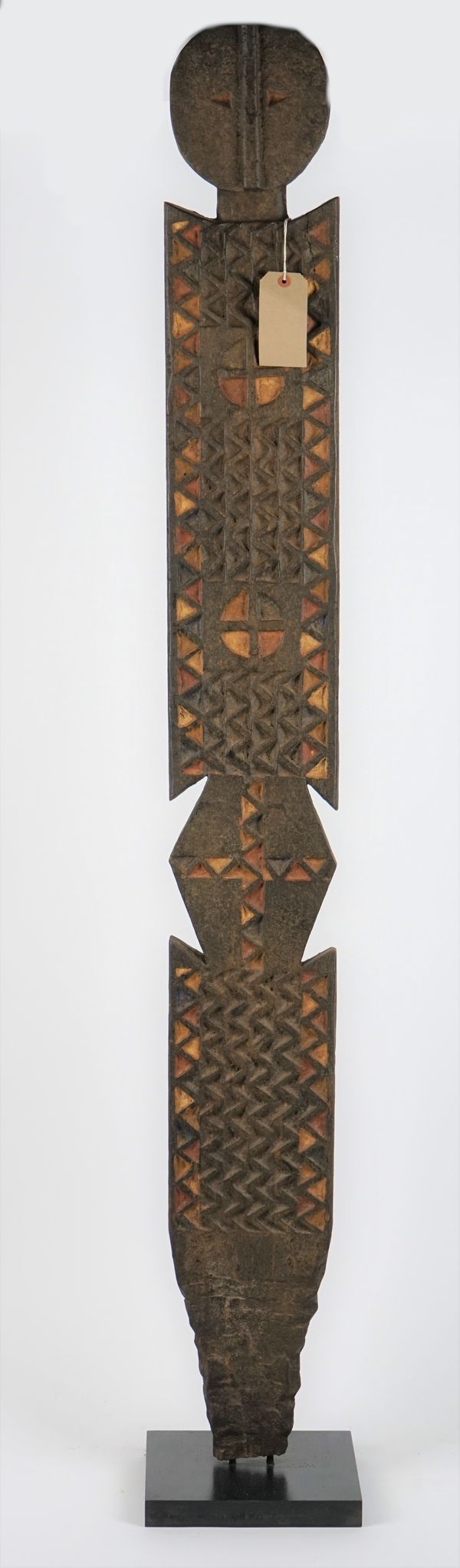 An African tribal totem pole on an ebonised square plinth, 170cm high.