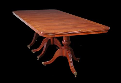 A George III style mahogany and burr walnut banded triple pillar dining table, two extra leaves, 275cm long x 381cm fully extended x 115cm wide.