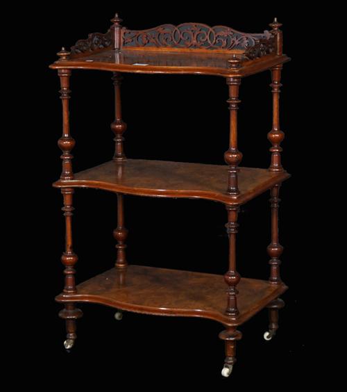 A Victorian walnut three tier serpentine what-not with galleried top, 55cm wide x 91cm high.