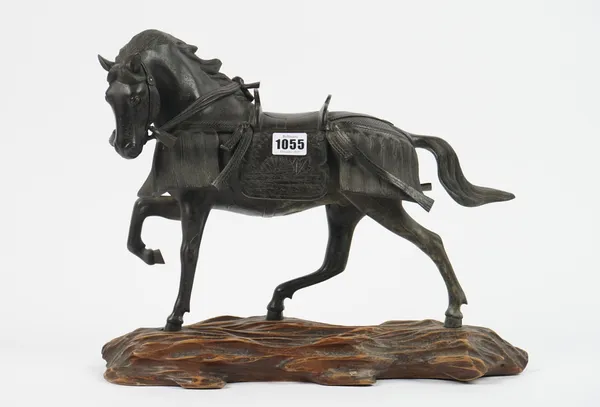 A Japanese patinated bronze horse, Meiji period, silver signature panel to base, on carved wood base, 33cm high.