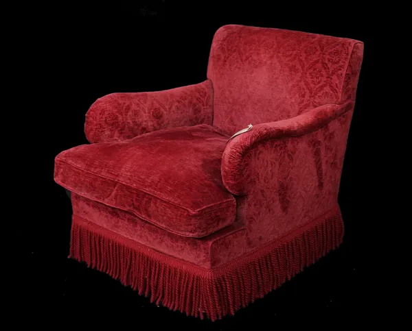 A modern Howard style armchair with red floral upholstery on block supports, 76cm wide x 79cm high.