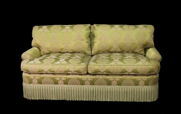 'Lewis Mittman Inc', a modern two seater sofa with green foliate upholstery and rollover arms, 187cm wide x 78cm high.