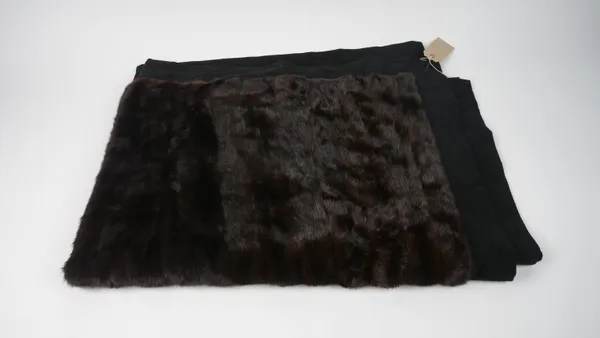 A dark brown fur throw, with black fabric border, 124cm x 167cm.