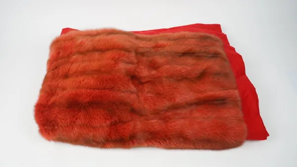 An orange/brown faintly striped faux fur throw, with red fabric border, 155cm x 196cm.