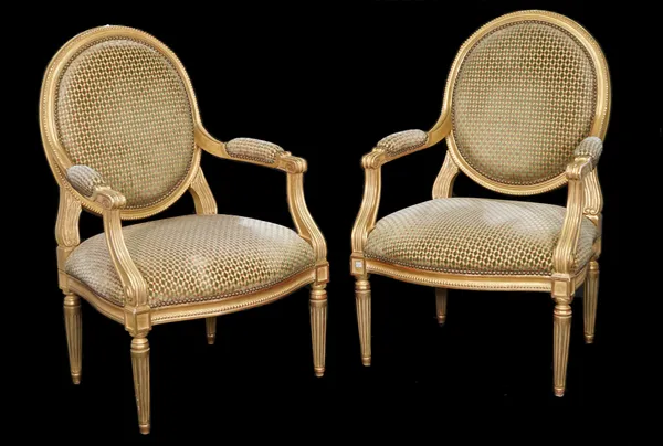 A pair of Louis XVI style giltwood fauteuils on fluted tapering supports, 65cm wide x 103cm, (2).