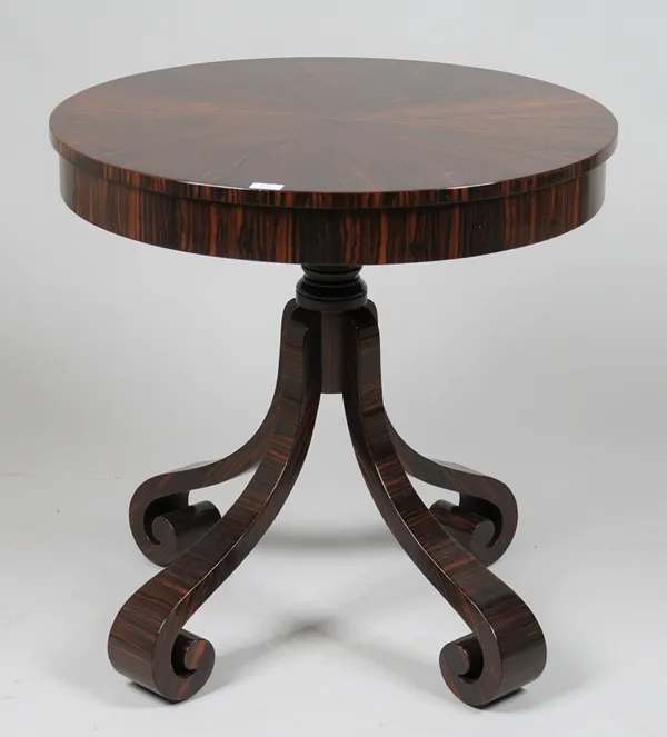 A modern walnut circular side table with single drawer on four outswept scrolling supports, 76cm diameter x 75cm high.