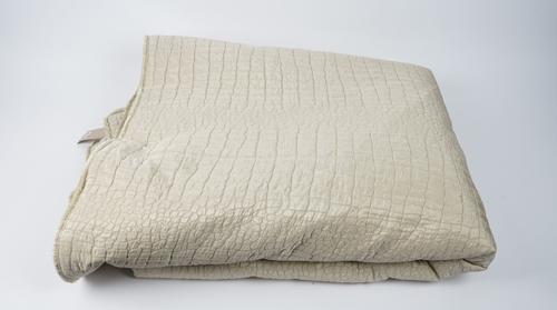A silvery/cream silk bed throw with qulited scale effect, 289cm x 297cm.