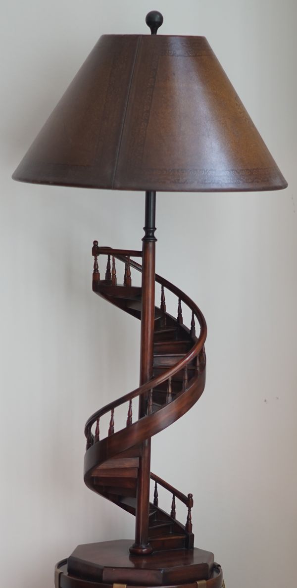 A stained wood table lamp, modelled as a spiral staircase, with leather shade, 100cm high.