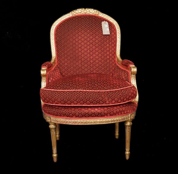 A pair of Louis XVI style giltwood armchairs with red upholstery on fluted tapering supports, 67cm wide x 103cm high, (2).