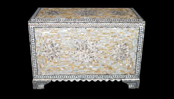 A modern mother-of-pearl decorated lift top trunk on bracket feet, 90cm wide x 61cm high.