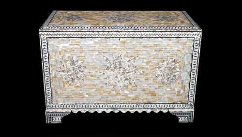 A modern mother-of-pearl decorated lift top trunk on bracket feet, 90cm wide x 61cm high.