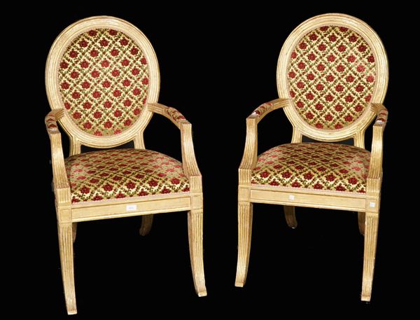 A pair of Louis XVI style giltwood fauteuils on fluted outswept supports, 56cm wide x 103cm high, (2).