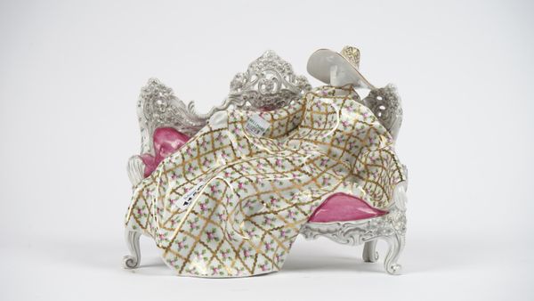 A Herend porcelain figure of a lady recumbent on a sofa (SPROG), first edition of 100, 24.5cm wide.