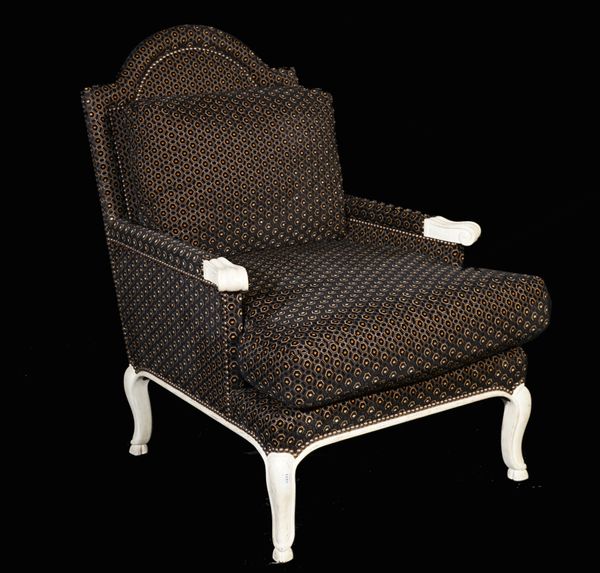 A Victorian style white painted armchair with brown/ black honeycomb pattern upholstery on cabriole supports, 68cm wide x 100cm high.