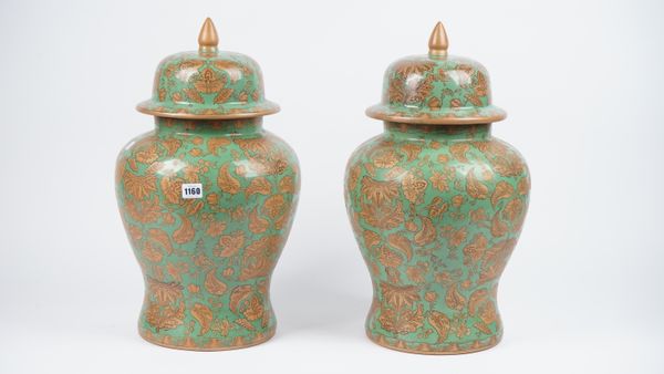 A pair of modern pottery urns and covers, each gilt foliate decorated against a green baluster ground, 52cm high, (2).