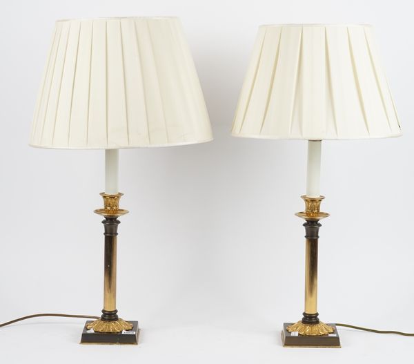 A pair of gilt and patinated metal lamps, modern, of fluted candlestick form, on a foliate cast square base, 35cm high, (2).