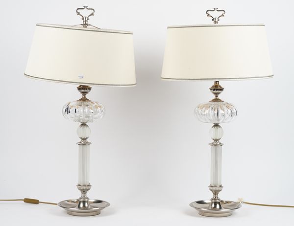 A pair of modern silvered metal and glass mounted table lamps, each on a circular dished foot, 50cm high, (2).