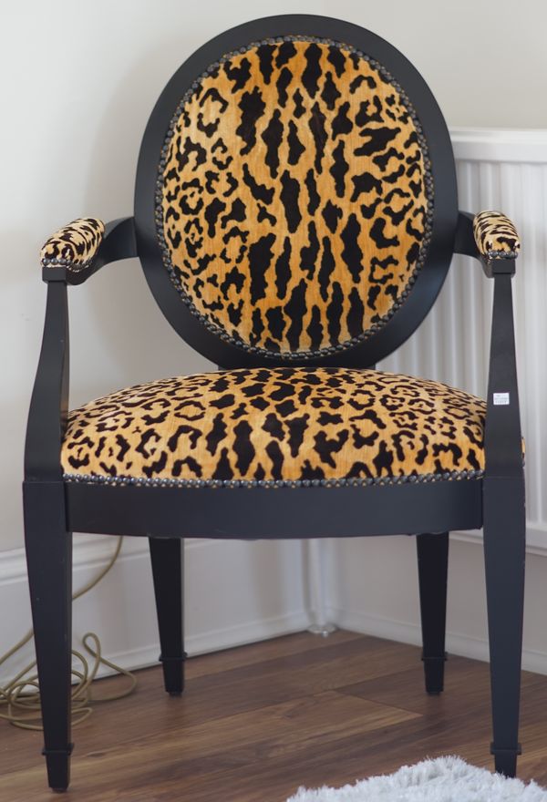 An ebonised faux leopard skin upholstered open armchair, 61cm wide x 96cm high.