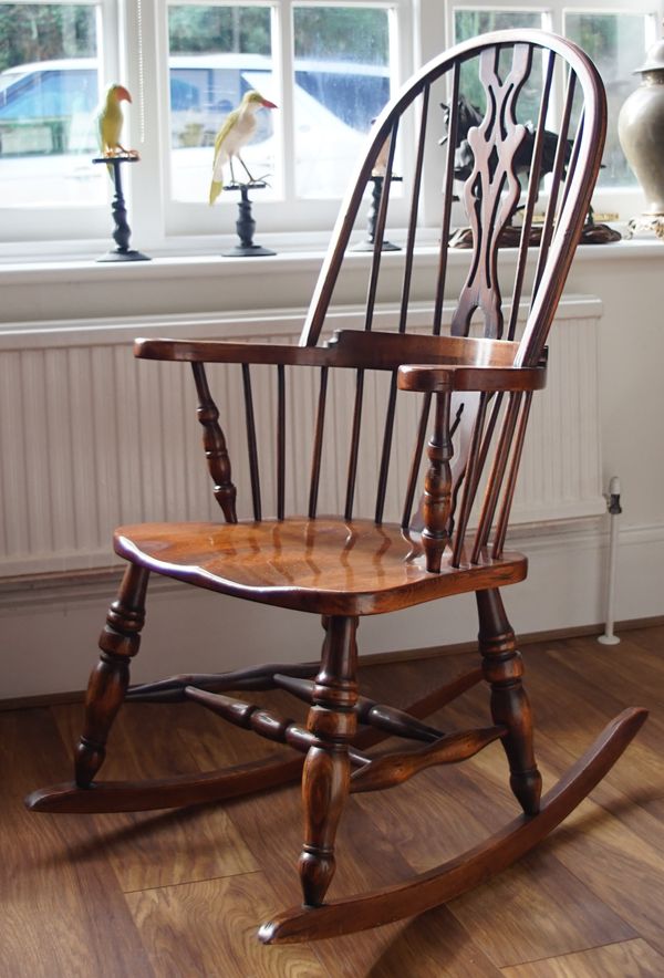 A modern ash and elm spindle back rocking chair, 64cm wide x 115cm high.