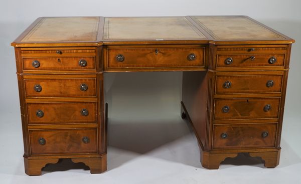 A modern inlaid mahogany inverted breakfront pedestal desk, with eight drawers about the knee, with a green leather inset top, 153cm wide x 79cm high.