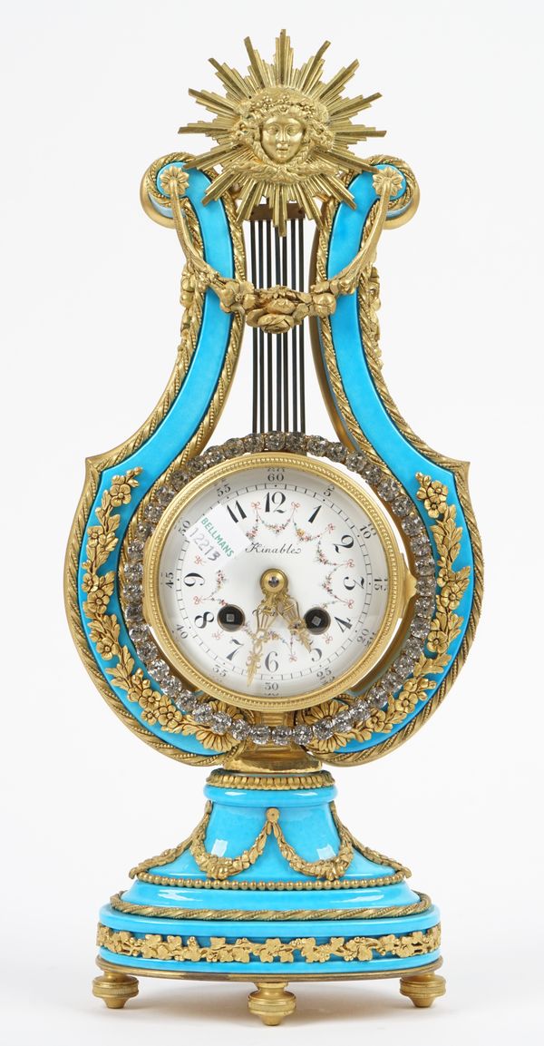 A Marie Antoinette style porcelain mantel clock with gilt metal mounts, detailed 'Kinables' to the foliate painted enamel dial, 35cm high.