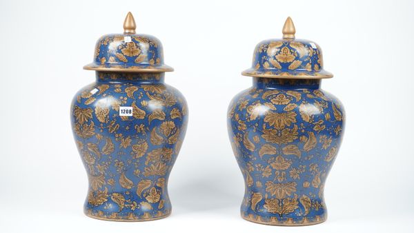 A pair of modern pottery vases and covers, each gilt foliate decorated against a blue baluster ground, 52cm high, (2).