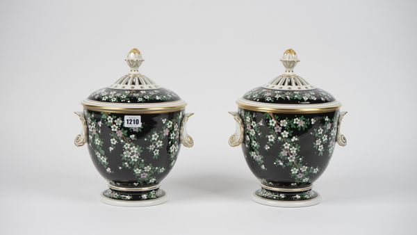 A pair of modern Dresden porcelain vases and covers, each foliate decorated against a background with gilt shell moulded handles and pierced covers, b