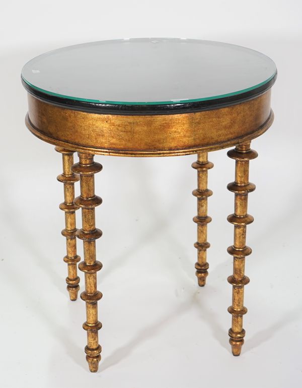 A modern giltwood circular occasional table, with ebonised elm top, on heavy bobbin turned supports, 60cm wide x 71cm high.