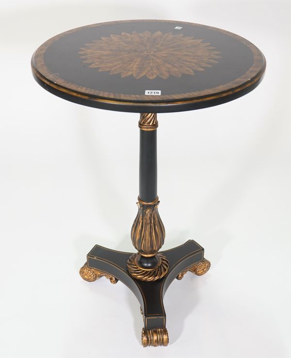 A Regency style black and parcel gilt painted circular occasional table, on turned column and scrolling supports, (A.F) 53cm diameter x 78cm high.