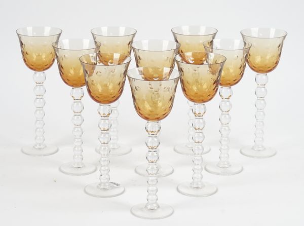 A set of ten of St Louis Crystal wine glasses, each with thumb cut orange glass bowls and segmented globular stem on a circular foot, engraved marks,