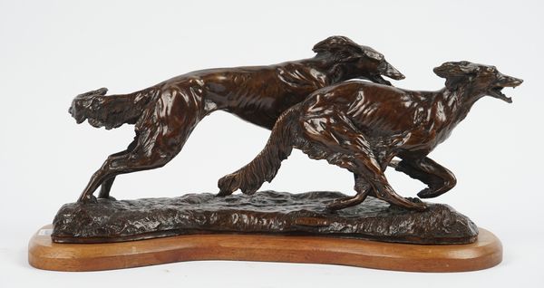 A modern patinated bronze group 'The Chase', depicting two running hounds on an oak plinth, 45cm wide.