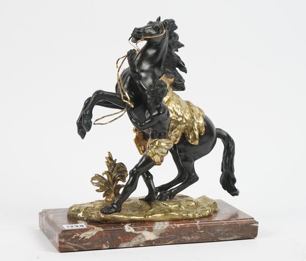 After Coustou, a gilt and patinated bronze Marley horse raised on a marble plinth, 32cm high.