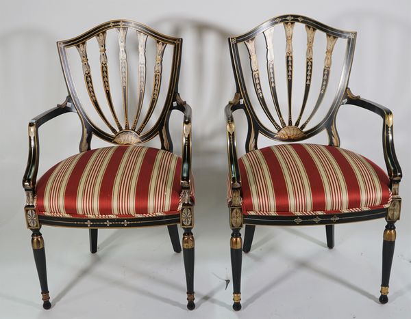 A pair of Regency style polychrome painted, shield back open armchairs, 57cm wide x 96cm high, (2).