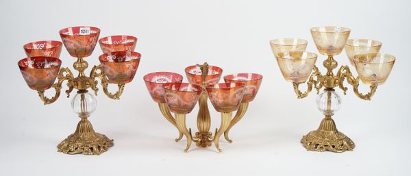 A similar pair of glass mounted gilt metal five branch table centrepieces, with foliate foot, 35.5cm high, and another similar smaller centrepiece, (3