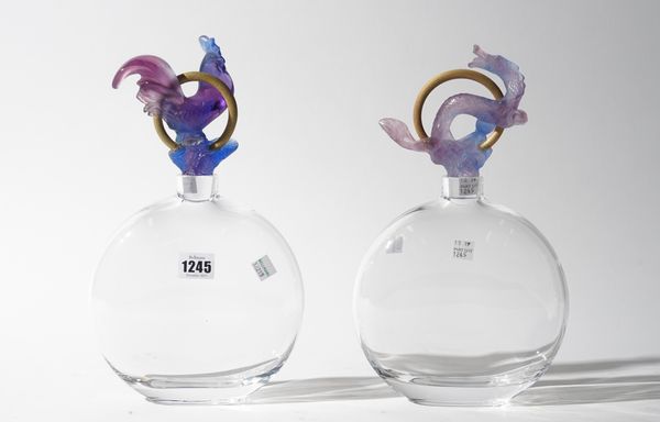 Daum France; a pair of modern glass moonflask scent bottles and stoppers, the coloured stoppers moulded with a dragon and a cockerel, with a gilt meta