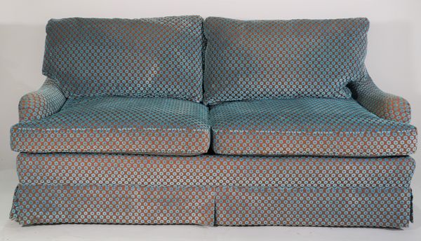 Edward Ferrell; a modern low two seater sofa, on tapering square supports with blue floral upholstery, 180cm wide x 80cm high.