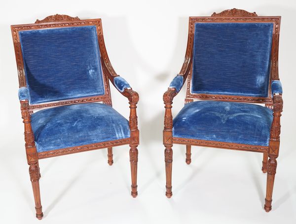 A pair of George III style mahogany blue upholstered open armchairs, on acanthus fluted tapering supports, 62cm wide x 107cm high.