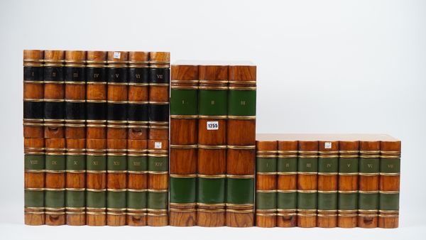 Three Victorian style wooden boxes, each carved and painted as a stack of seven leather bound books, 40.5cm wide, and a matching table top cupboard, 4