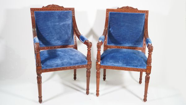 A pair of George III style mahogany framed open armchairs, with blue velvet upholstery, on acanthus fluted tapering supports, 62cm wide x 107cm high,