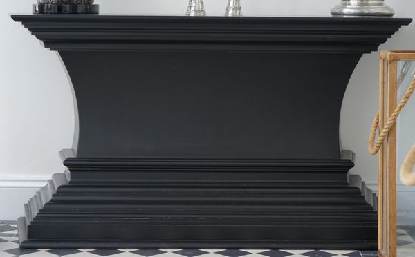 A modern ebonised console table, on tapering plinth base, 150cm wide x 80cm high.