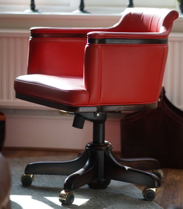 A pair of modern red leather upholstered desk chairs, 62cm wide x 83cm high.