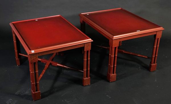 A pair of modern red lacquer side tables, on faux bamboo block supports, 70cm wide x 45cm high, (2).