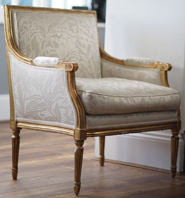 A pair of Louis XVI style giltwood bergere chairs, 87cm high, (2).