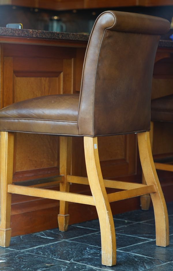 A set of eight tan leather upholstered bar stools, 48cm wide x 99cm high, (8).