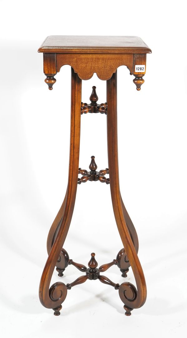 A 19th century Continental style mahogany jardiniere stand with leather upholstered top, on four outswept supports, 36cm wide x 102cm high.