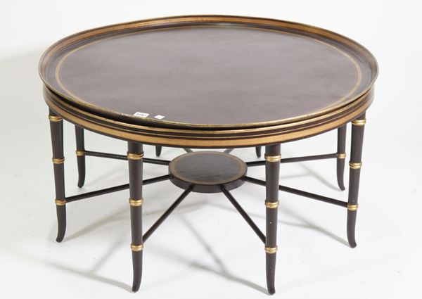 A modern ebonised and parcel gilt decorated circular metal tray on a wooden base, 87cm diameter x 47cm high.